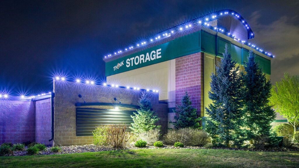 Permanent Trimlight holiday lighting installed on a commercial storage facility
